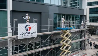 Professional commercial painters applying exterior coating in San Diego, CA business building
