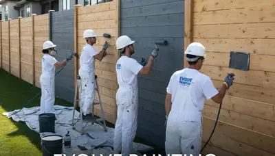 Professional fence painters staining wood fence in San Diego, CA for lasting coastal protection