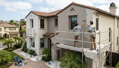 Professional house painters finishing exterior home painting in San Diego, CA