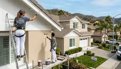 Professional house painters coating residential exterior in San Diego, CA