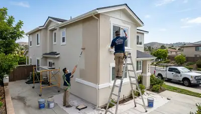 Professional house painters working on residential exterior in San Diego CA